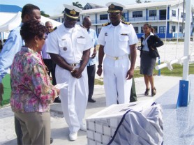 The widow of former Coast Guard Commander Harry Hinds, Jacqueline Hinds (left) ,  after she unveiled a plaque in her husband’s honour at the Coast Guard Unit , Ruimveldt. Prime Minister Samuel Hinds (second from left), Coast guard Commander Godfrey George (third from left) and Commodore Gary Best look on. (Photo by Heppilena Ferguson)                                                                                       