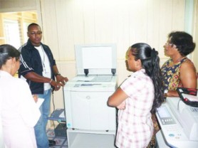 Headmistress of the St Ignatius Secondary School Yvette Archer-Alexander (left) listens to the CCS Technician while the school’s information technology teacher, Basmattie Drupaul (right) and Project Trust Country Director Kala Seegopaul (second from right) look on.   