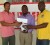 Thanks again! Guymine.com representative Dexter Prembroke (Centre) hands over the website’s contribution to this years tournament to organizers Kashif Mohammed (left) and Aubrey ‘Shanghai’ Major (Rawle Toney Photo) 