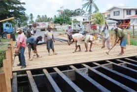 Workers from the Ministry of Works repairing the Dennis Street-Stone Avenue bridge yesterday. (Photo by Jules Gibson)