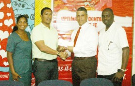 Kashif Muhammad receives the sponsorship cheque from Carlton Joao of Banks DIH Limited. (Orlando Charles photo)