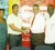 Kashif Muhammad receives the sponsorship cheque from Carlton Joao of Banks DIH Limited. (Orlando Charles photo)
