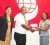 Rawl Davson, Vice-President of the Guyana Hockey Board receives the sponsorship cheque from Jennifer Cipriani, Manager of Products and Marketing of Scotia Bank Limited while Tricia Fiedtkou - Assistant Secretary/Treasurer of the GHB looks on. 