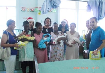 Bundles of holiday cheer: On Christmas Day, staff of the Princess Hotel distributed gifts to mothers and their newborn babies at the Georgetown Public Hospital’s Maternity Ward as well as children who were forced to spend the holiday in the Paediatric Ward. In photo, mothers with the newborns are flanked by hotel staff, including General Manager Muharrem Kulekci (extreme right), who donated diapers, among other items. 