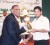 Ramnaresh Sarwan receives his award from West Indies Cricket Board CEO Dr. Ernest Hilaire. (Orlando Charles photo) 