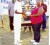 Secretary of the BCB Angela Haniff hands over the TENELEC Inc. trophy to successful Captain Loydel Lewis.