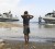 A Haitian boy watches as rigid-hull inflatable boats from the amphibious dock landing ships USS Fort McHenry and USS Carter Hall arrive ashore at the New Hope Mission in Bonel, January 19, 2010. REUTERS/Petty Officer 2nd Class Kristopher Wilson/U.S. Navy/ Handout
