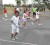 Getting it right! Tennis coach Shelly Daly Ramdyhan (in back ground) pays rapt attention while students carry out the drills during yesterday’s mini-tennis programme in the National Park (Aubrey Crawford Photo)