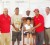 Little Charlise Adams strikes a pose with prize winners and officials of the Lusignan Golf Club.