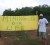 Local businessman, Roger Hinds standing in front of a sign at the Mahdia airstrip last week. 