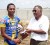 National cycling coach Hassan Mohammed presents the first place prize to Geron Williams. (Orlando Charles photo)