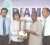 General Manager of Diamond Fire and General Insurance Company, Tara Chandra (2nd L) hands over the sponsorship cheque and championship trophy to vice president of the BCB David Black as the company’s Christopher Williams (L) and BCB marketing consultant, Bish Panday (R) look on.