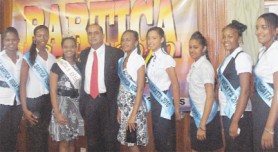 Some of the contestants of the Miss Bartica Regatta Pageant along with last year’s winner  stand with Tourism Minister Maniram Prashad at the Ministry of Tourism, Industry and Commerce after the launch of this year’s Bartica Regatta.  