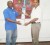 ICC World Twenty20 West Indies 2010 Tournament Director, Robert Bryan, presents Minister of Culture, Youth and Sport Dr. Frank Anthony with his personalized “Bring It” bat.  