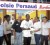 Kenneth Semple (centre)receives his cheque from a sales representative of Toolsie Persaud Ltd. Also in the photo are TPL Manager Mohan Harnanan (third from left), club Treasurer Petal Lashley (second from left) and coach John Martins (right). (Orlando Charles photo)          