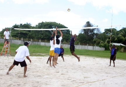 A Guysuco Training Centre Player (second left) goes for the spike in the game against Park All Stars Saturday at the Aracari Resort. (Orlando Charles Photo)