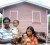  A Princeville family standing in front of their new home.