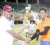 Devendra Bishoo is presented with his MVP trophy from organise of the tournament Paul Bonar (left) or DJ Stress last Saturday. (Orlando Charles photo)