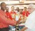 Secretary of the Guyana National Rifle Association Ryan Sampson left receives the trophy from Dr. Jose Da Silva of Modern Optical.