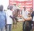Delon Sancho and Ian John (left) of the Norman Singh Memorial Turf Club present the winner’s trophy to Miss Lisa Gopaul of the Crawford Stable for victory in the F class event.   