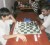 (Chess Feng and Singh): Sue-Hai Feng (left) and opponent Niatanand Singh ponder the board during their round three “Game of the Round” match of yesterday’s game.
