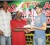 Ansa McAl’s Marketing Assistant John Maikoo (right) hands over the winning cheque to the captain of the Mix Up dominoes team while tournament organizer Lyall Gittens looks on at left.