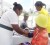 Two visitors to the health fair held at the East La Penitence Health Centre have their blood pressure tested by nurses.