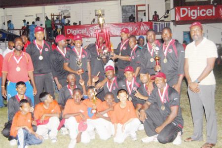 The DCC team proudly displays the Digicel Trophy after a convincing win over GNIC yesterday at the DCC ground. 