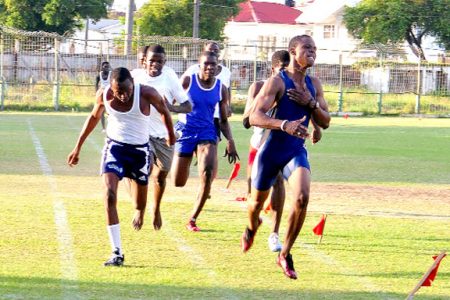 Nationals athlete Carl Lewis leads  a thrilling finish in the boys under-20 100m heats yesterday. (Photo by Orlando Charles) 