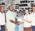 Ameena Jadoonandan of 2Js General Store hands over the MVP award to Fruta Conquerors’ Ivor Thompson in the presence of her fellow employee and Fruta Conquerors president Marlan Cole. (Orlando Charles photo)	