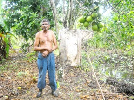 Rudolph Gobin standing next to a ‘scarecrow’ at his farm at Lord Robert Grant, Pomeroon last week. (Gaulbert Sutherland photo) 