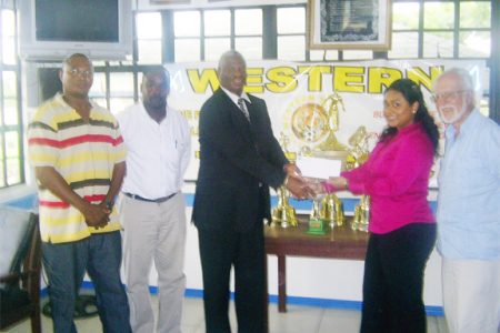 BK International’s Alexis Tiwari (second right) hands over the sponsorship for the first prize of the inaugural Western Tigers Super Eight to club President Gordon Gilhuys while members of the Western Tigers board and Kit Nascimento (right) look on. 