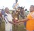 Ivan Dipnarine (in white and blue T-shirt) presents his trophy in the three-year-old Derby to Krishna Jagdeo Jr. 