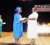 One of the graduates as she receives her certificate 