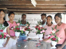 The girls display their completed floral arrangements.