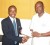 Daryl Warner, left,  FIFA’s  Technical Development Officer for the Caribbean Region  hands over the donation to Aubrey ‘Shanghai’ Major.  