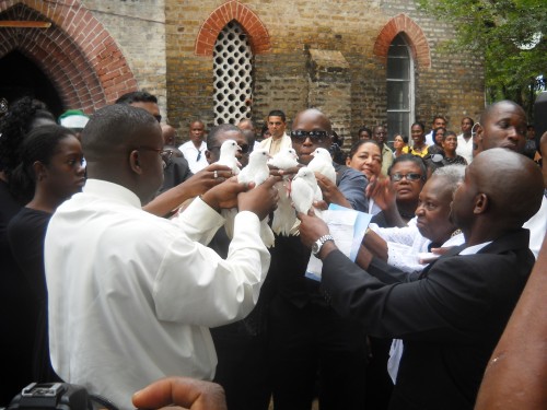 Relatives and close associates of Winston Murray about to release doves following the funeral service in Leguan today. 