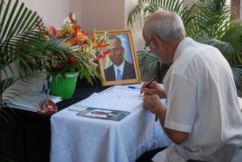 Fr Malcom Rodrigues SJ signs the book of condolence at Parliament Buildings today at the viewing of Winston Murray’s body as it lay in state from 10:00 hrs to 12:30 hrs. (Photo by Jules Gibson)