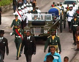 The carriage drawn casket bearing the body of the late Prime Minster