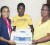 Members of the Rose Hall Town Youth and Sports Club and the Berbice Cricket Board display the $120,000 Desktop Photocopier.