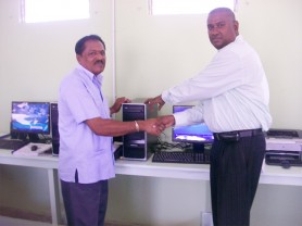 Regional Chairman Ali Baksh (left) receiving the computers from Project Manager Michael Singh