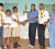 Queen’s College “A” team captain, Cecil Cox (third from left) receives the winning team trophy from the Minister of Sport, Dr. Frank Anthony. From left is: Kitfai Sue, Devendra Singh, Elston Low and President of the Guyana Chess Federation, Errol Tiwari (photo by Orlando Charles). 