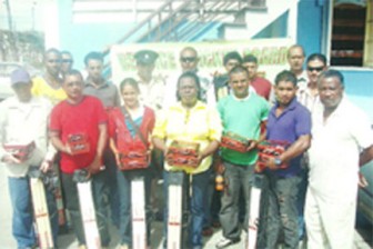 Representatives of receiving clubs pose with the cricket stumps and balls they received from the Berbice Cricket Board. Also in picture is BCB President Keith Foster (right).