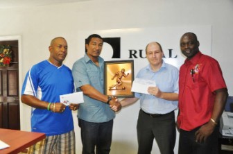 Chief Financial Accountant of Rusal, Andrey Gurin (second right) hands over the donation  to co-director of the Kashif and Shanghai organization Kashif Muhammad (second left) while Aubrey ‘Shanghai’ Major (right) and Christopher Morris (left) share the moment.