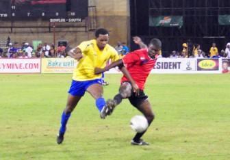 Alpha United’s Dwight Peters (right) tries to maintain possession against Pele’s top defender Charles ‘Lily Pollard in the finals. (Orlando Charles Photo)