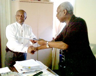Carl Greenidge (left) hands over his papers to PNCR General Secretary Oscar Clarke.