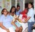 A beaming Donnette Griffith holds her newborn daughter as Teddies representative Melanie DaCosta presents her with a hamper. Medical Arts maternity staff look on.