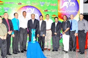 Chief Executive Officer of GT&T, Yog Mahadeo (centre) and President Bharrat Jagdeo (fifth left) display the 2011 GT&T 10/10 Softball Competition trophy, among the other dignitaries at yesterday’s launching of the tournament (Orlando Charles Photo)