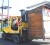 Not quite mobile vending: A bobcat moving a stall from one half of Sussex Street to another as La Penitence Market vendors yesterday began voluntarily removing from Saffon Street where road extension is scheduled to begin on Thursday.  (Photo by Jules Gibson) 