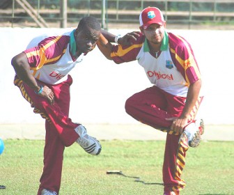 Ramnaresh Sarwan, right and Kemar Roach doing stretches yesterday. (Windiescricket.com) 